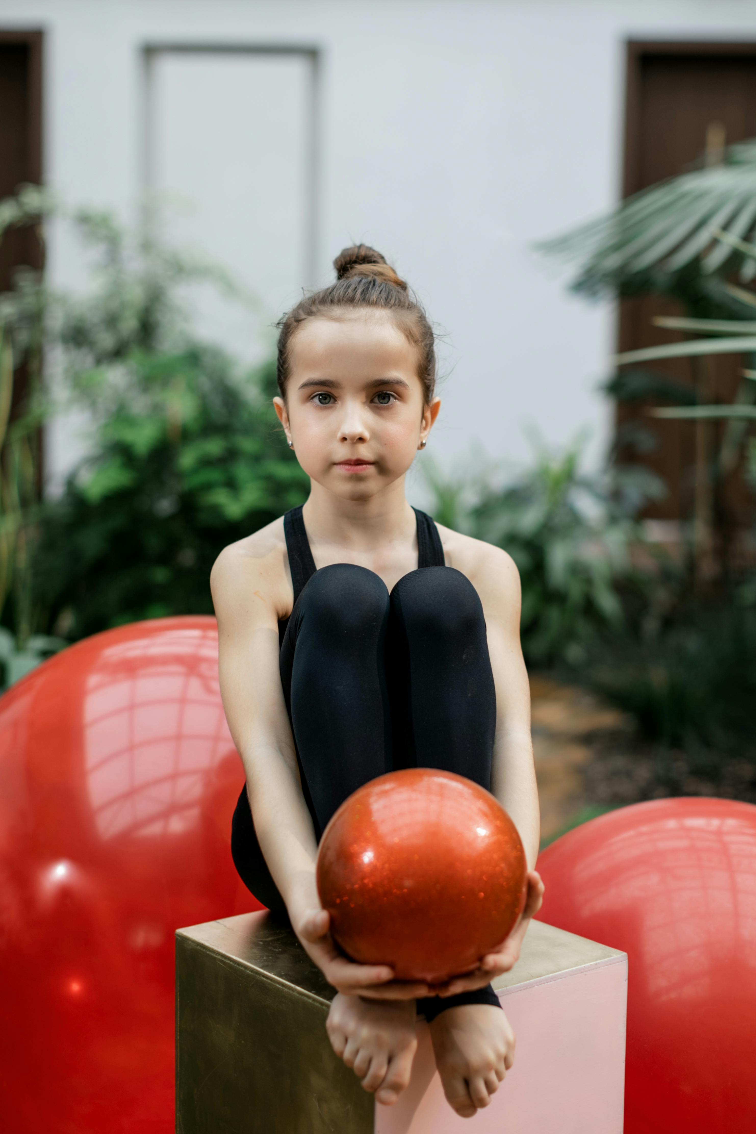 girl holding a red ball