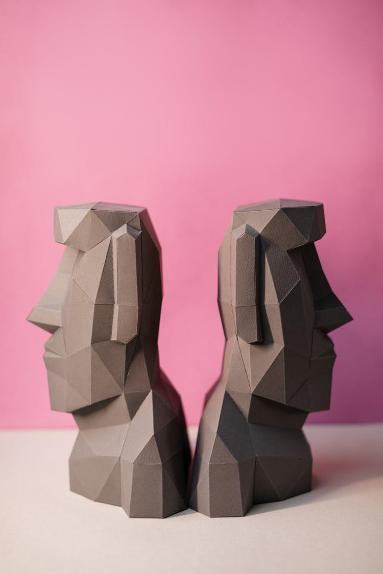 Geometric Human Head Figures On Pink Background