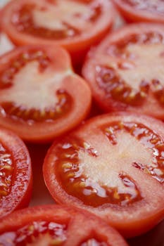 Vibrant close-up of fresh red tomato slices for healthy food concepts.