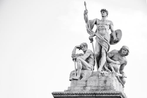 Photo of Statues of Three Men Isolated on White Background