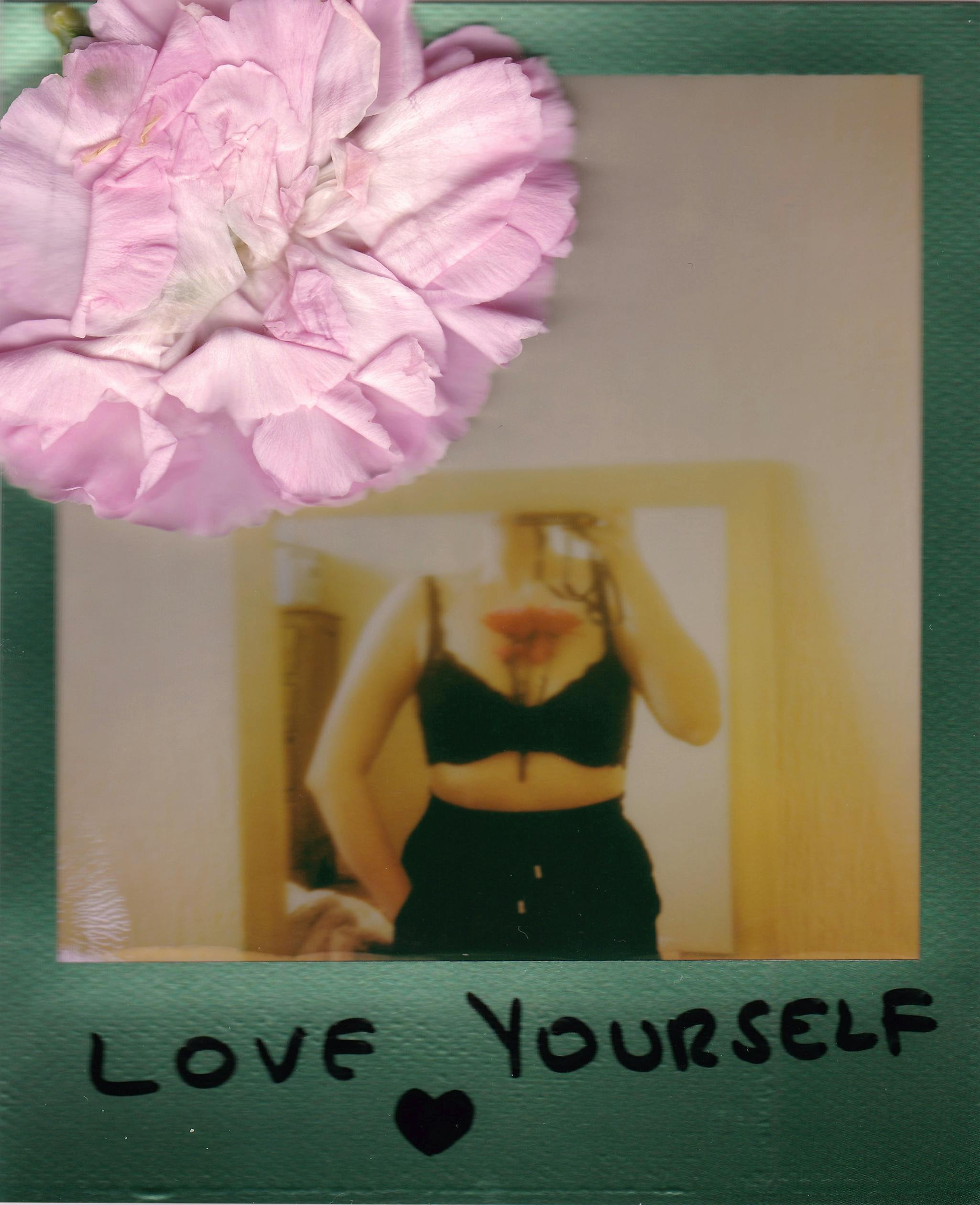Polaroid photo with a flower accent encouraging self-love, featuring a woman in a bra.