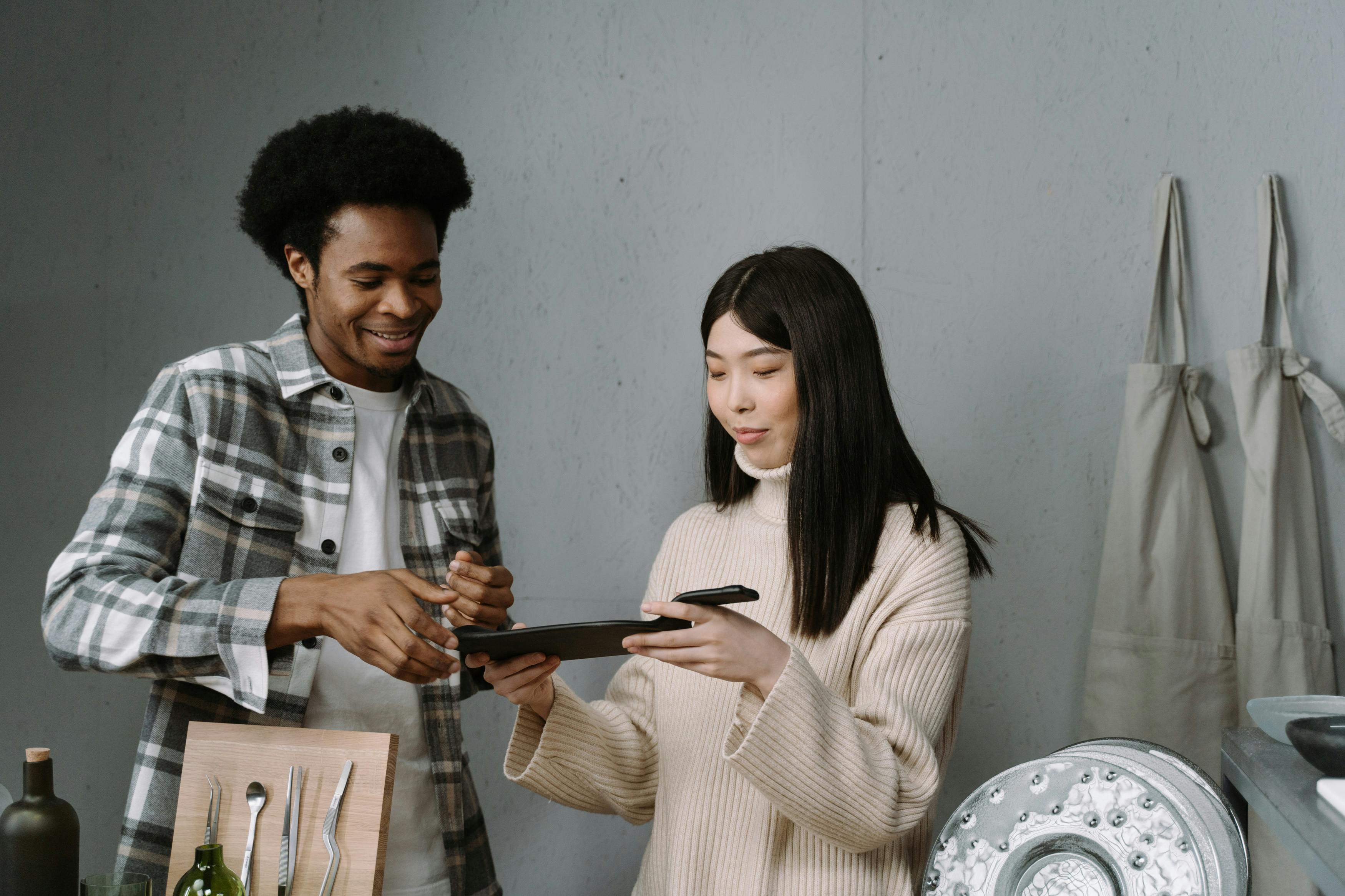 A man and woman engaged in a sales discussion over tableware in a modern store.