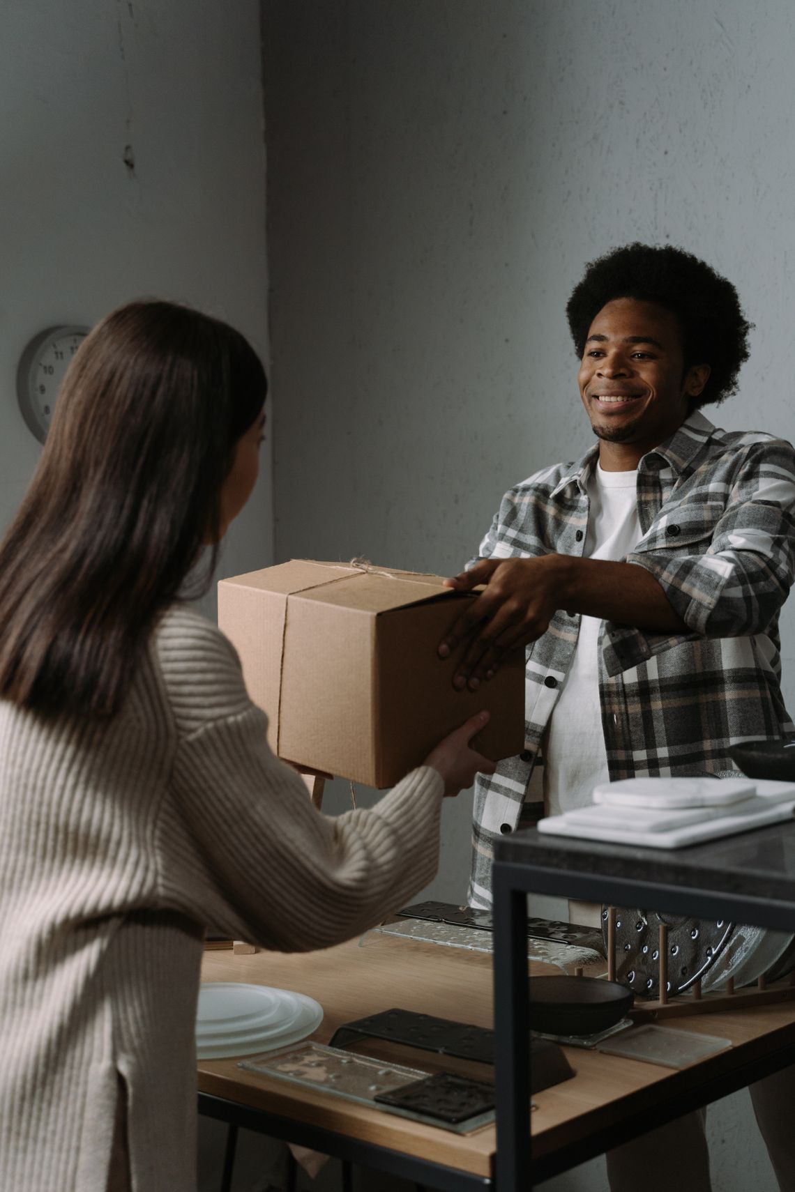 Customer receiving a package from a delivery person