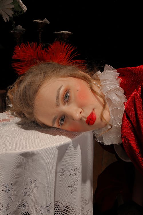 Model with red lips leaning on table