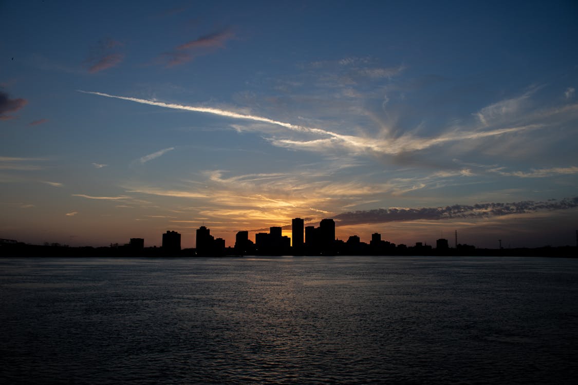Silhouette of City Skyline near the Sea during Sunset