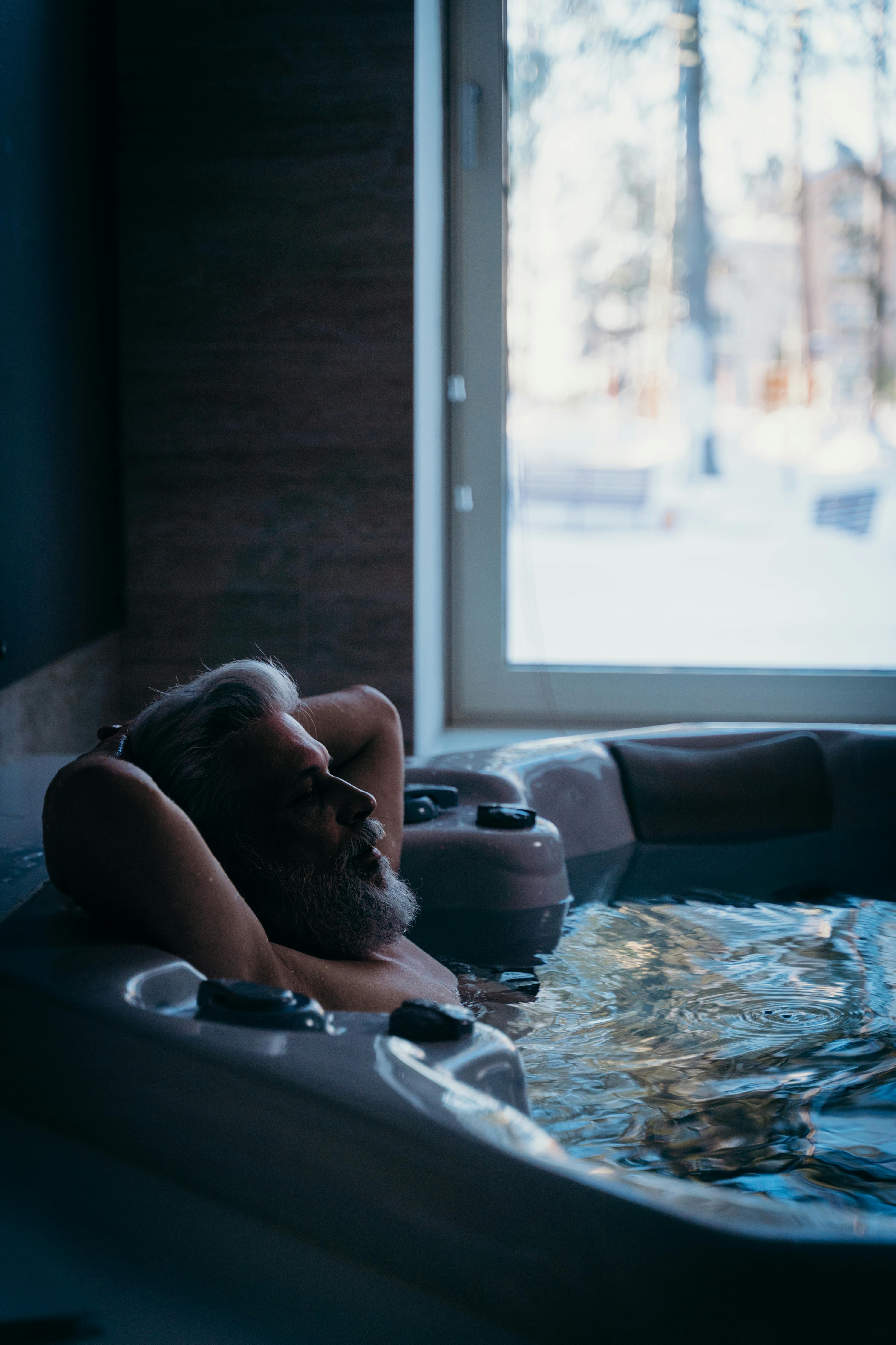 an elderly man in a bathtub