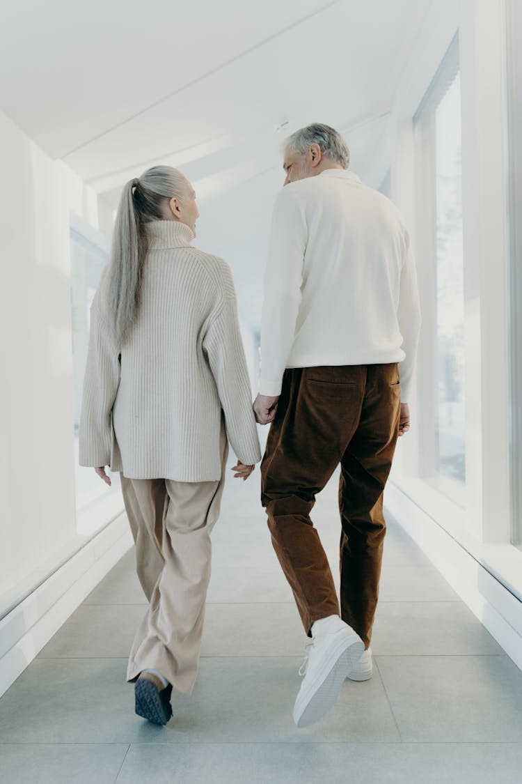 Man And Woman Walking At A Hallway