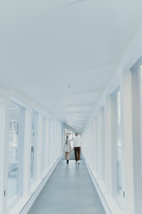 A Couple Walking Together on Hallway