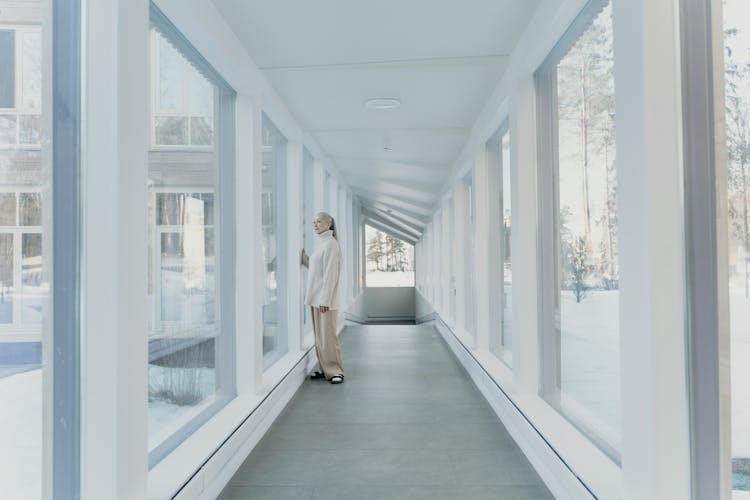 A Woman Standing By The Window