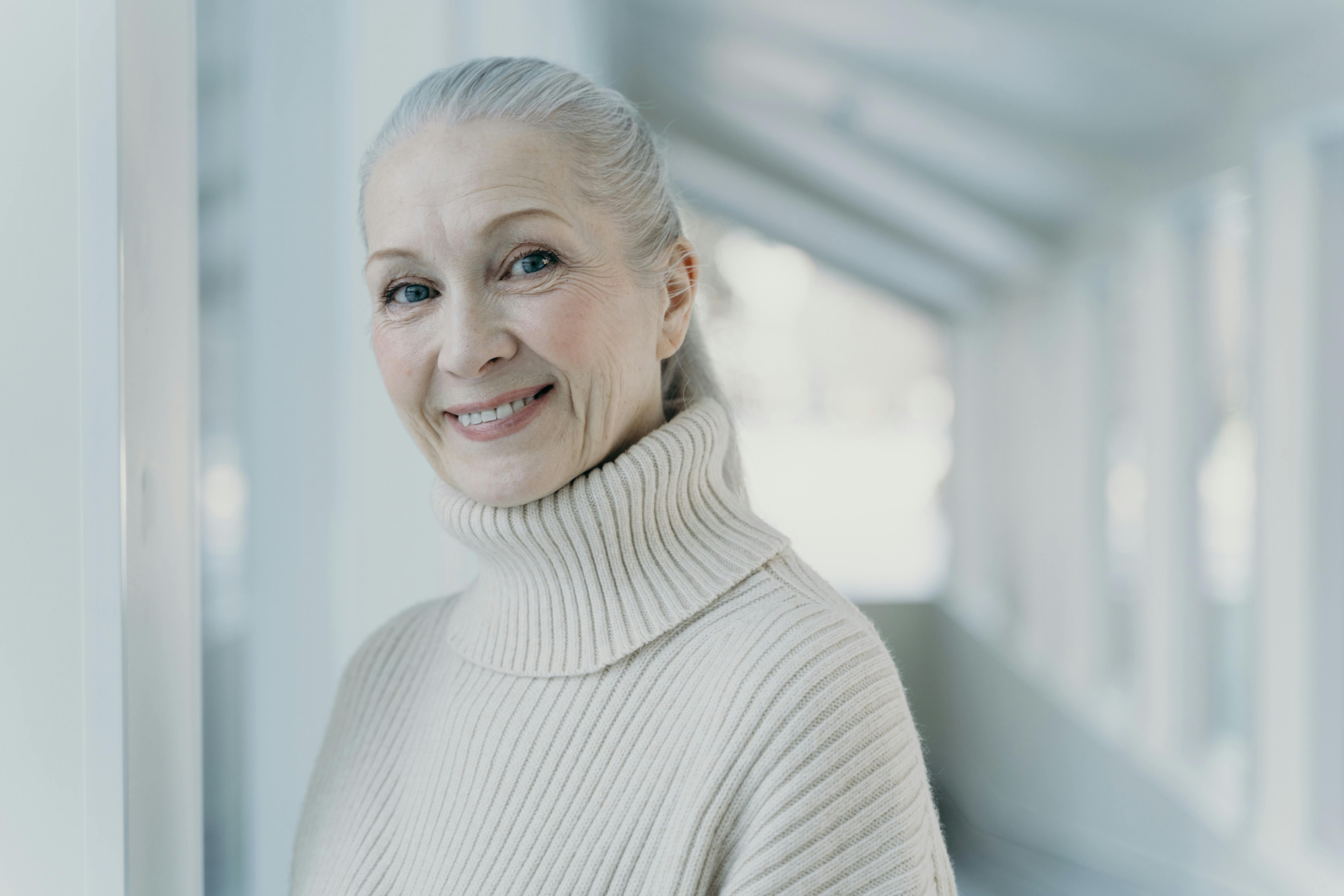 smiling woman in turtleneck sweater