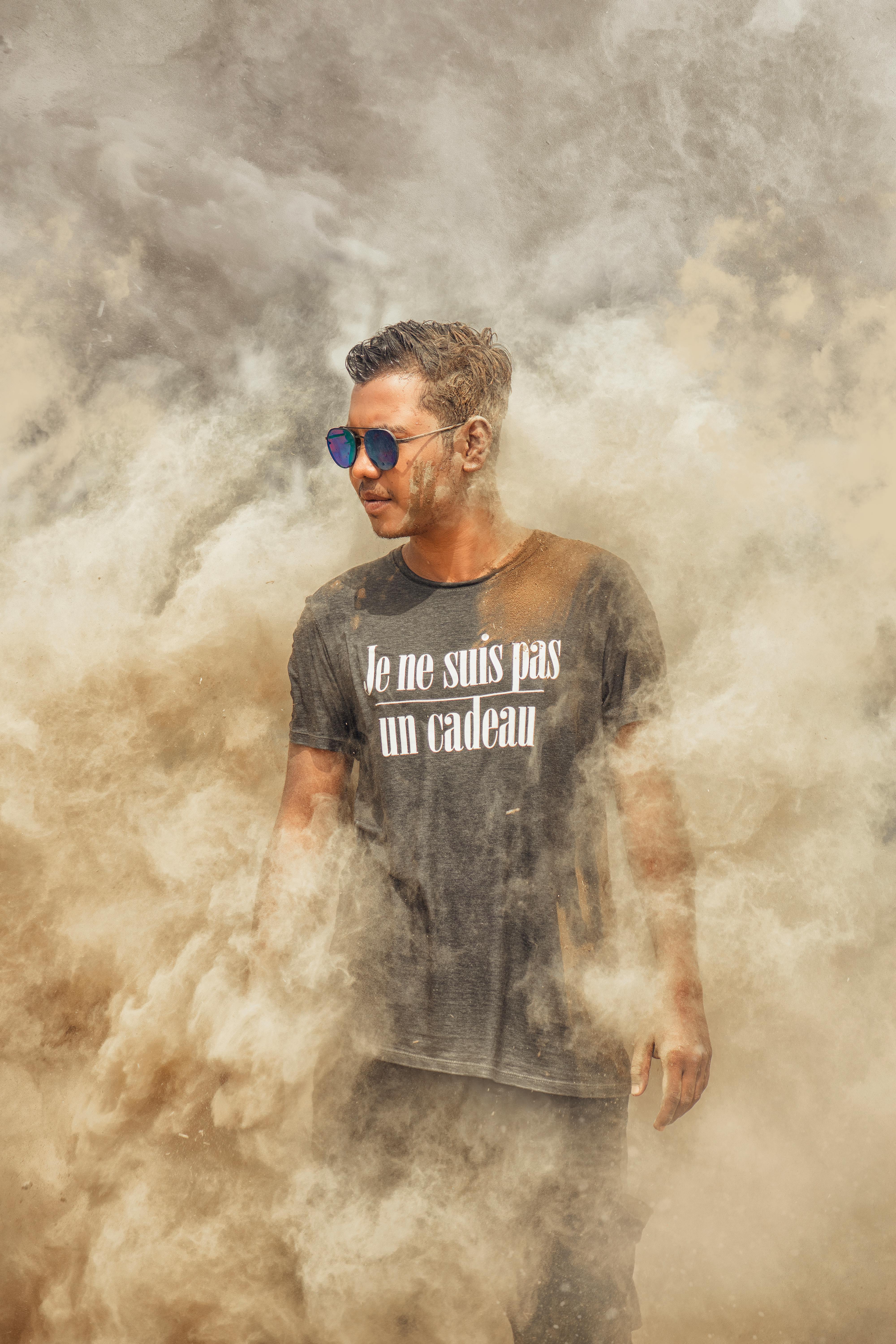 man in black crew neck t shirt with white smoke