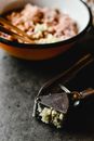 Black and Red Ceramic Bowl With Brown Wooden Ladle