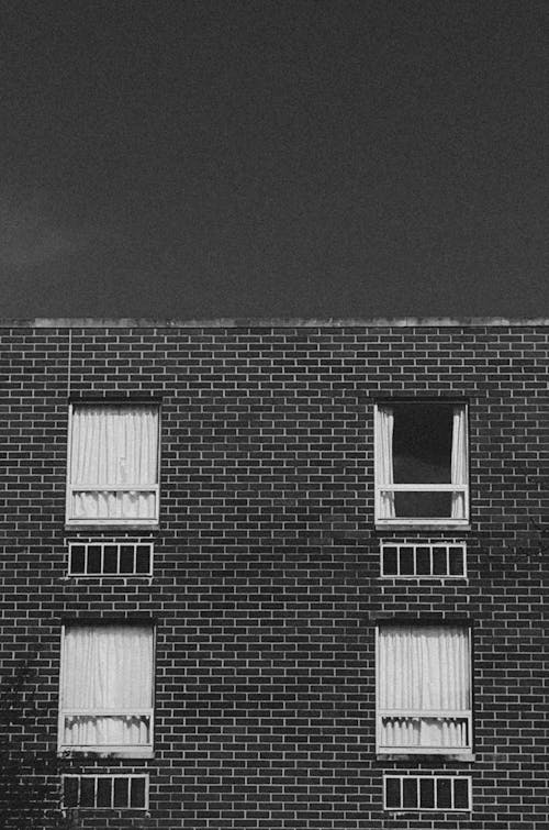 Grayscale Photo of a Brick Building