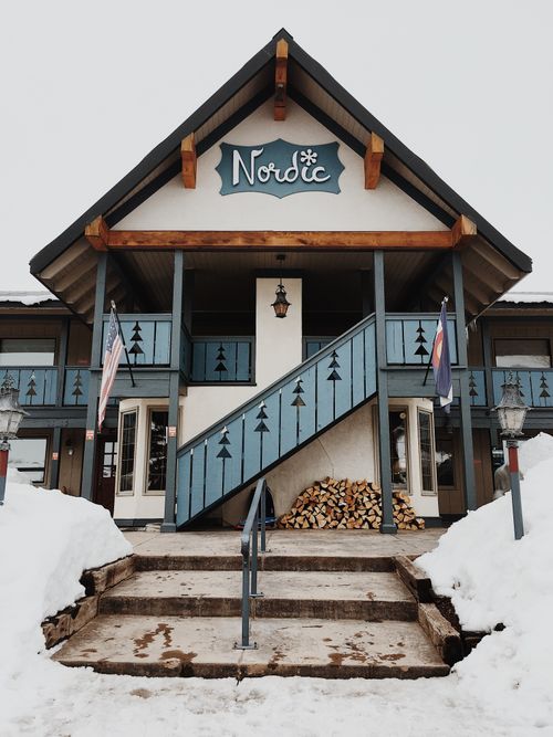 Free Charming Nordic-style building with wooden accents and snow-covered entrance in Crested Butte, Colorado. Stock Photo