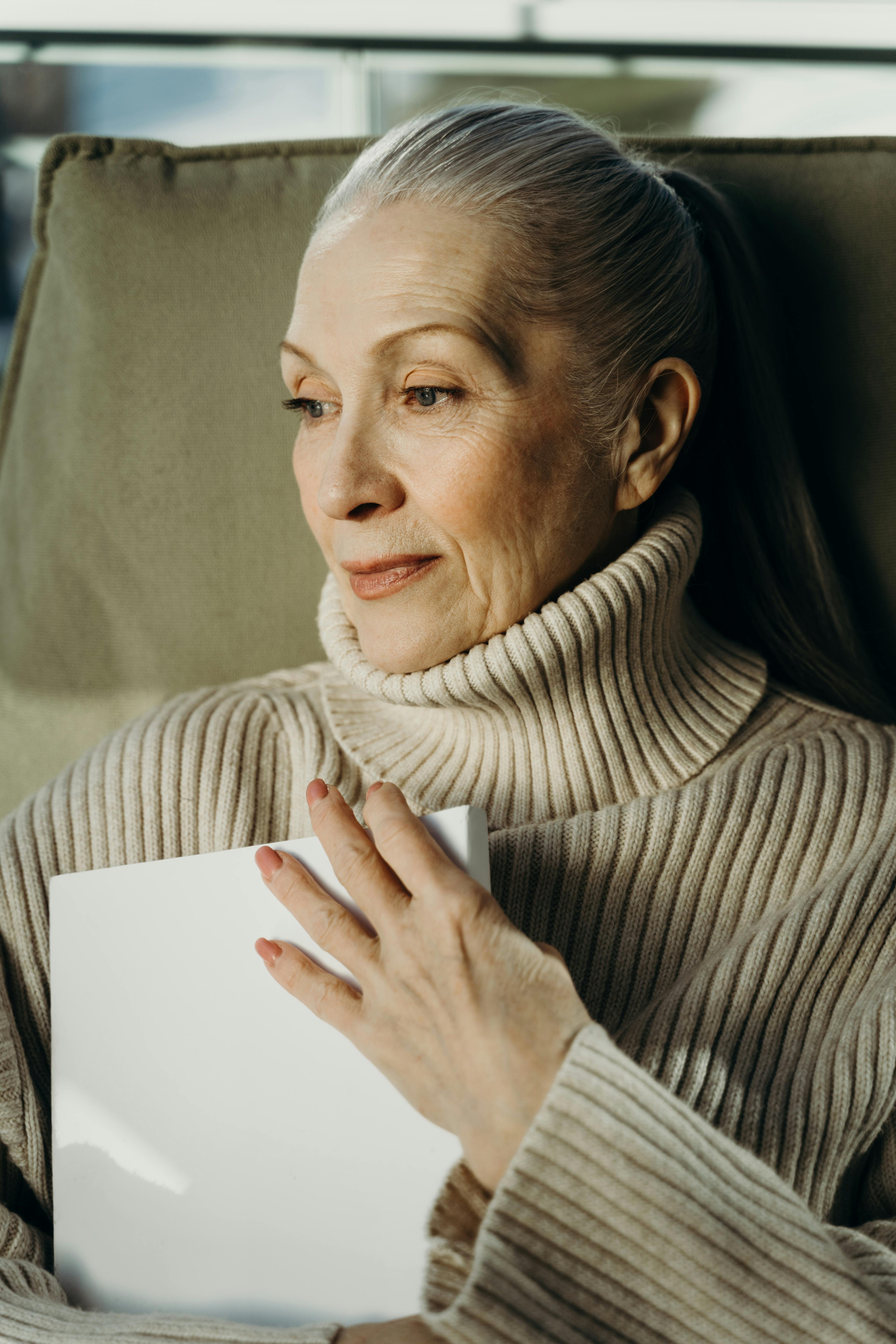 an elderly woman in beige turtleneck sweater