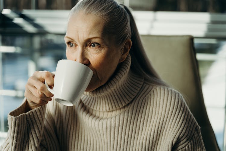 A Woman Drinking A Coffee