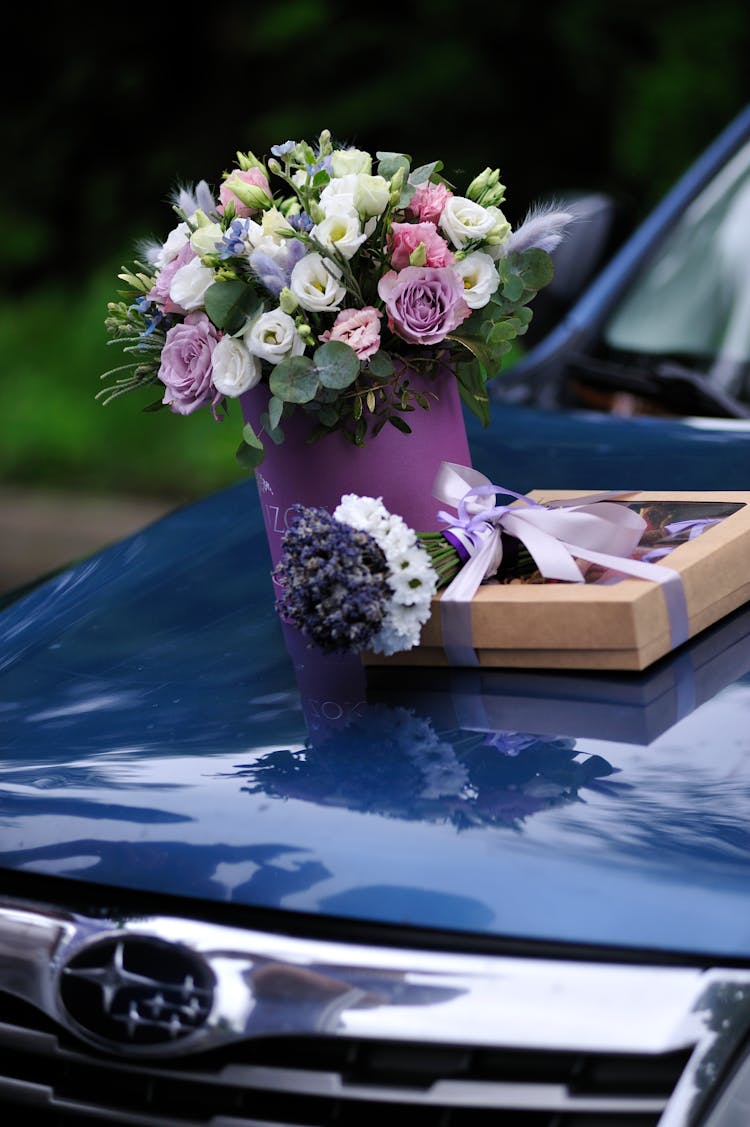 A Bouquet Of Flowers On Subaru Car Hood