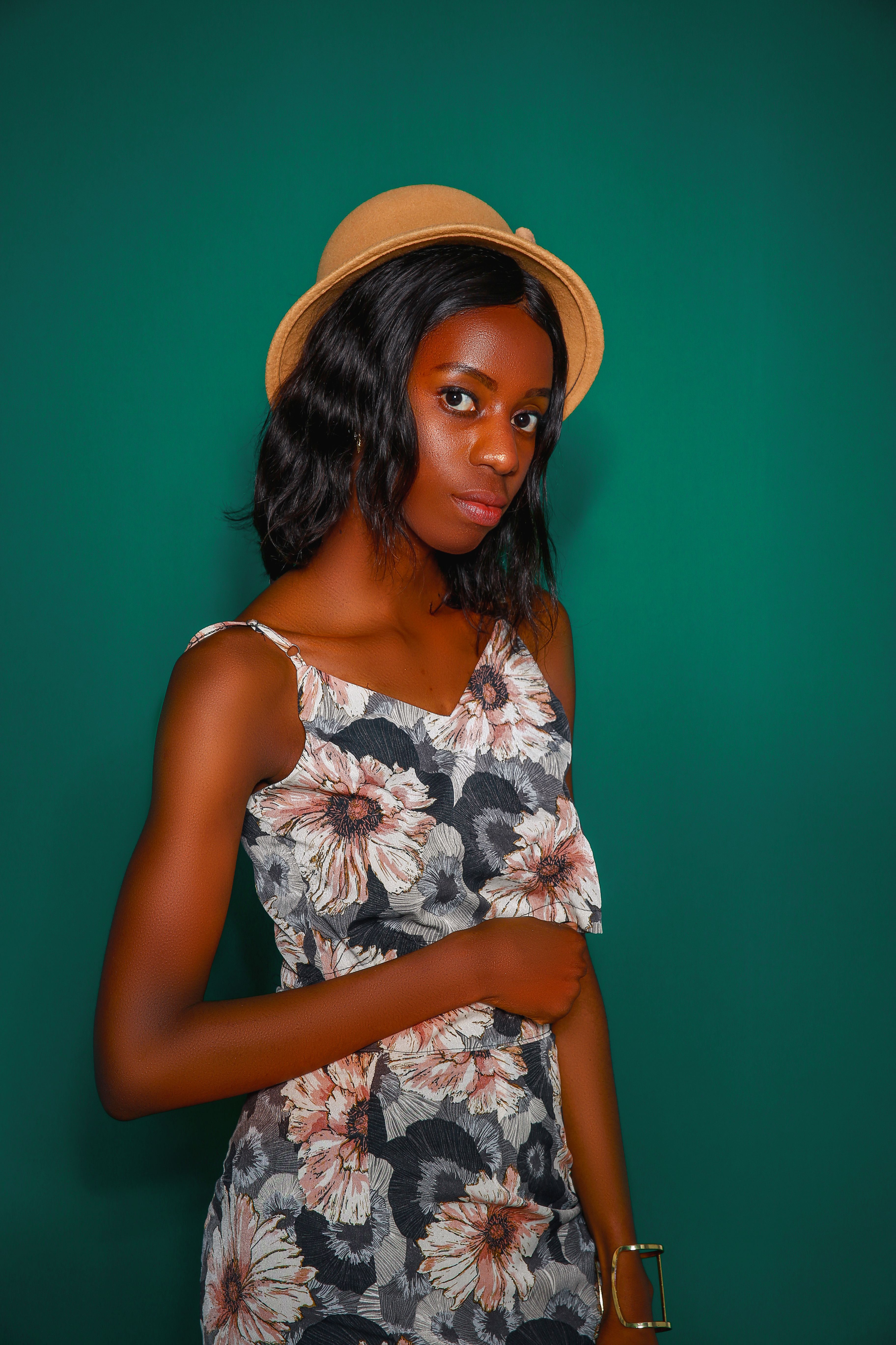 Photo of Woman in Floral Top Posing While Looking Away · Free Stock Photo