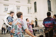 A Man in Hawaiian Shirt Playing the Drums