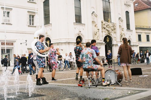 A Group of Musicians Performing Near Water Fountain