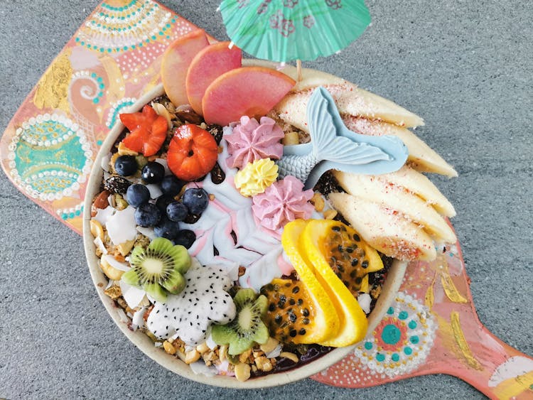 Close-up Of A Bowl Full Of Fruit, Sweets And Nuts 