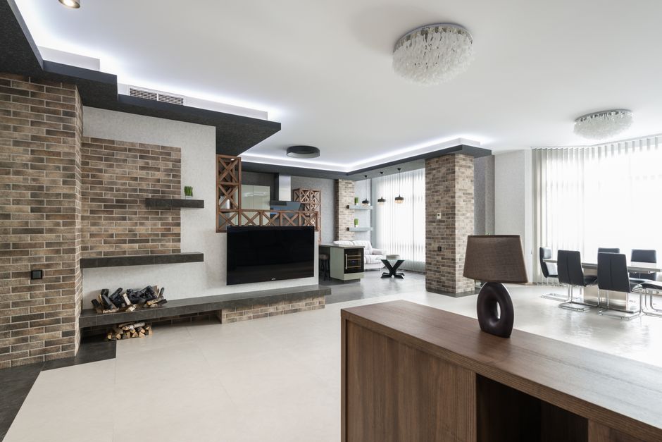 Photo by Max Vakhtbovych on Pexels Modern TV at decorated wall in spacious living room with wooden cupboard in light apartment with table near big window