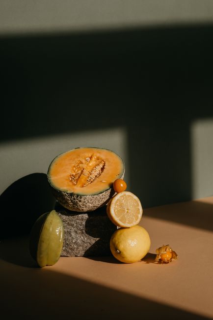 Stylish composition of fresh fruits under dramatic shadow lighting, highlighting healthy organic variety.