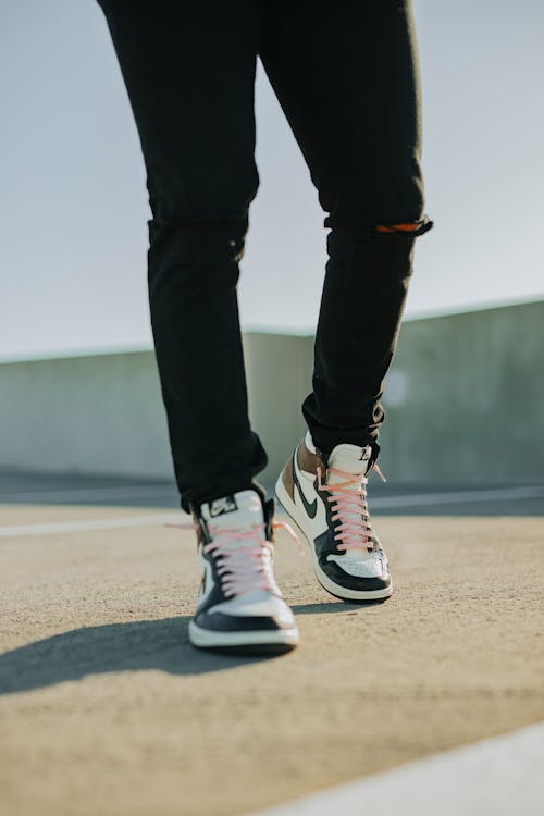 Free Person in Black Pants Wearing Sneakers Stock Photo