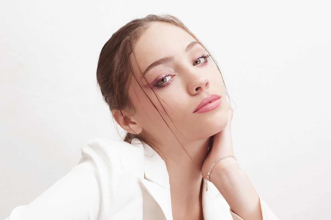 portrait of an elegant woman in a white blazer with glamorous makeup a
