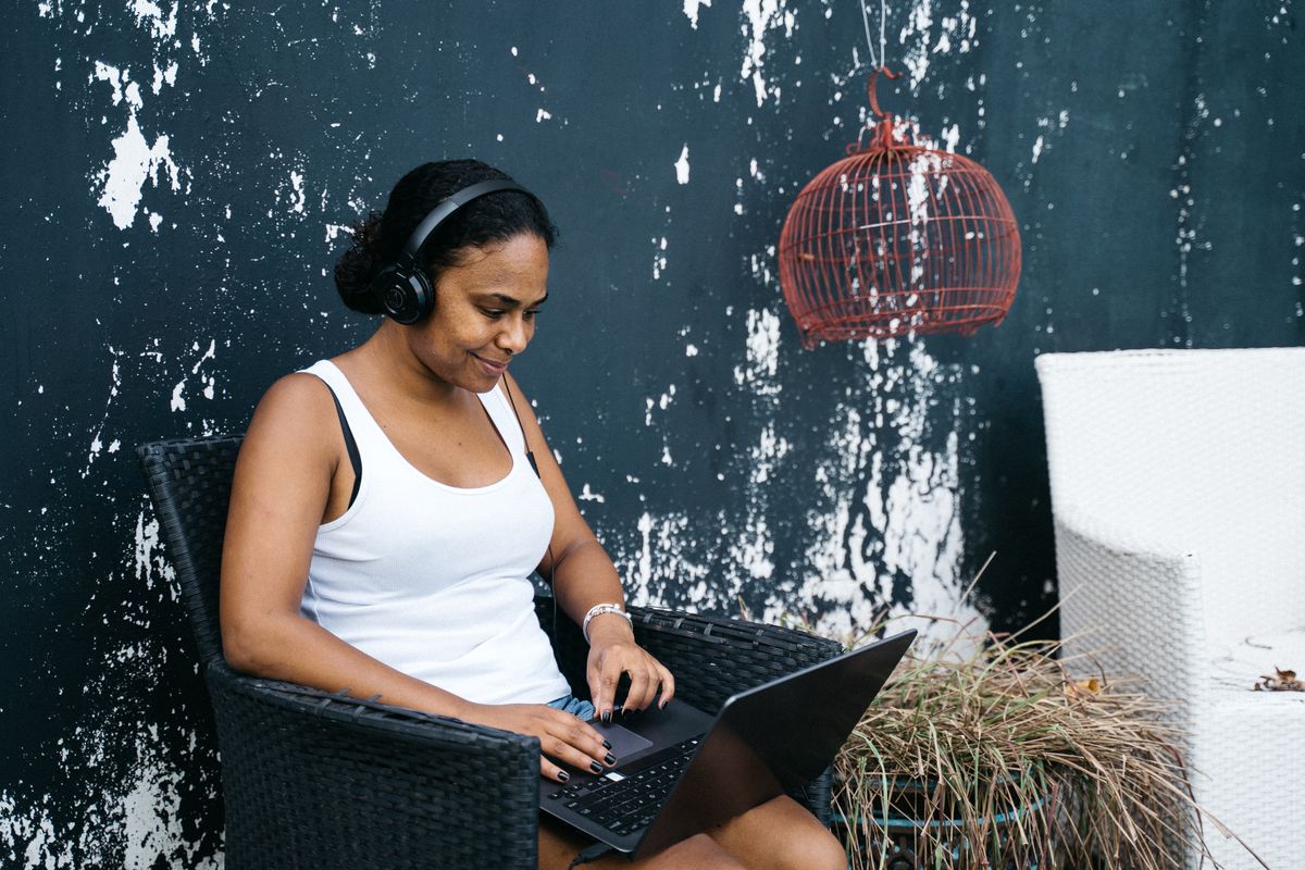 Nigerian freelancer sending outreach messages on a laptop