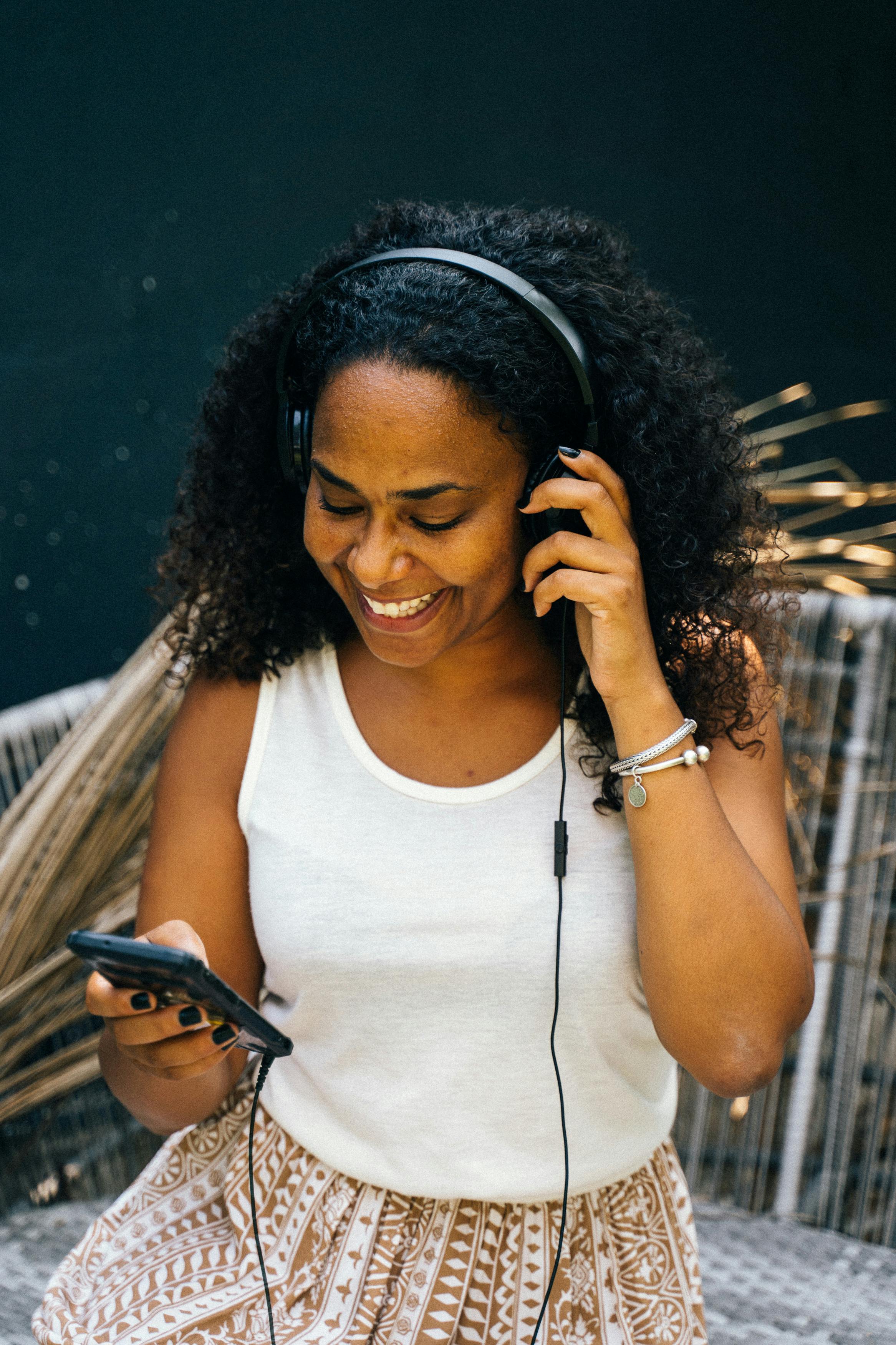 woman in white tank top wearing headphones