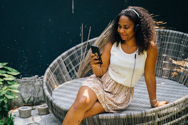 Woman With Headset Using Smartphone 