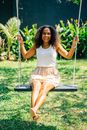 Woman in White Tank Top Sitting on Swing Chair