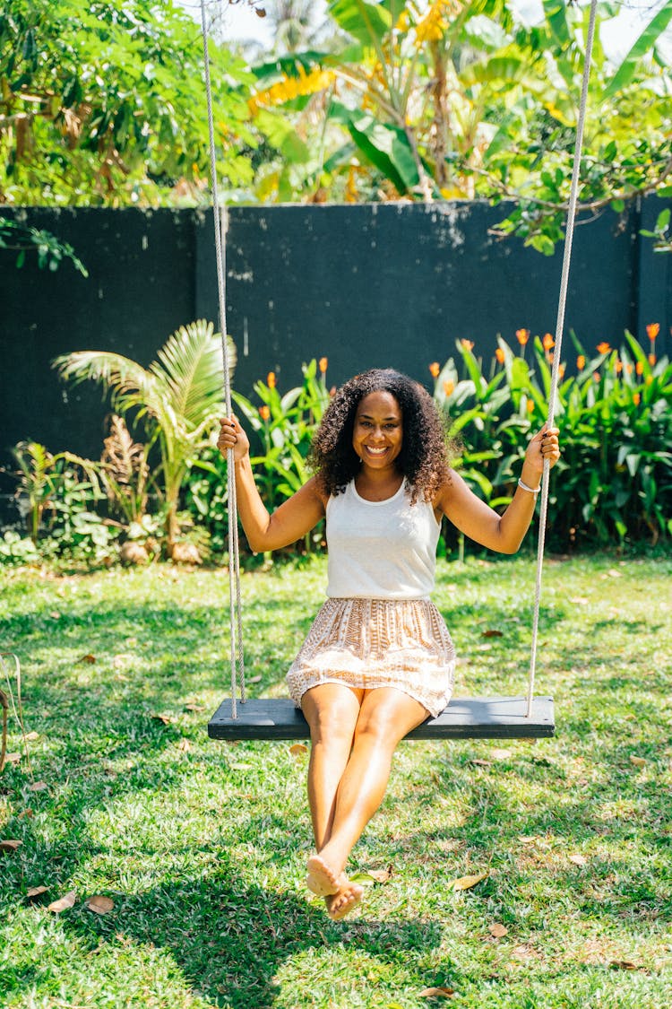 Happy Woman On A Swing