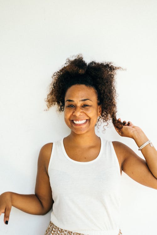 Woman in White Tank Top Smiling