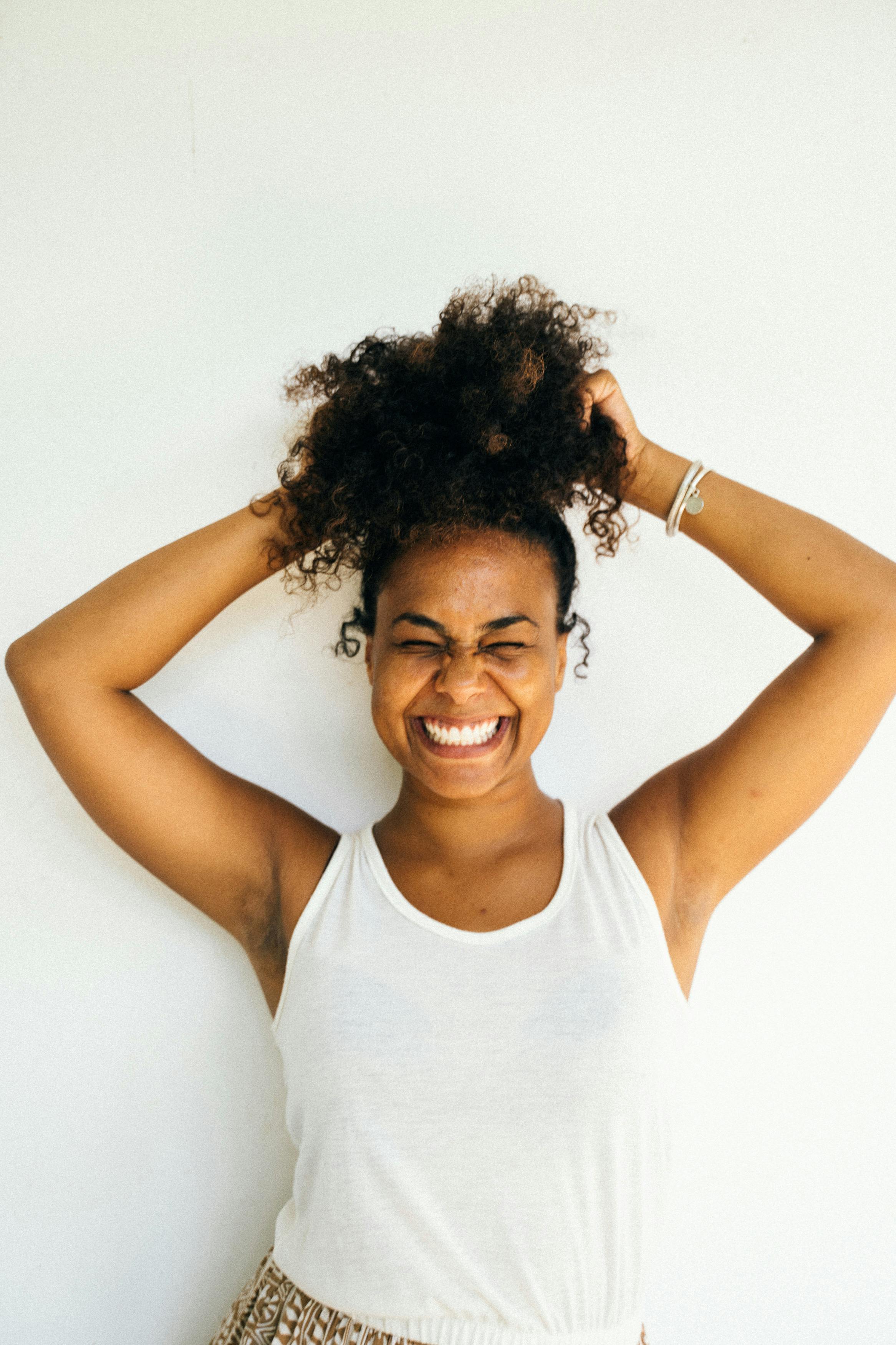 a happy woman in white tank top