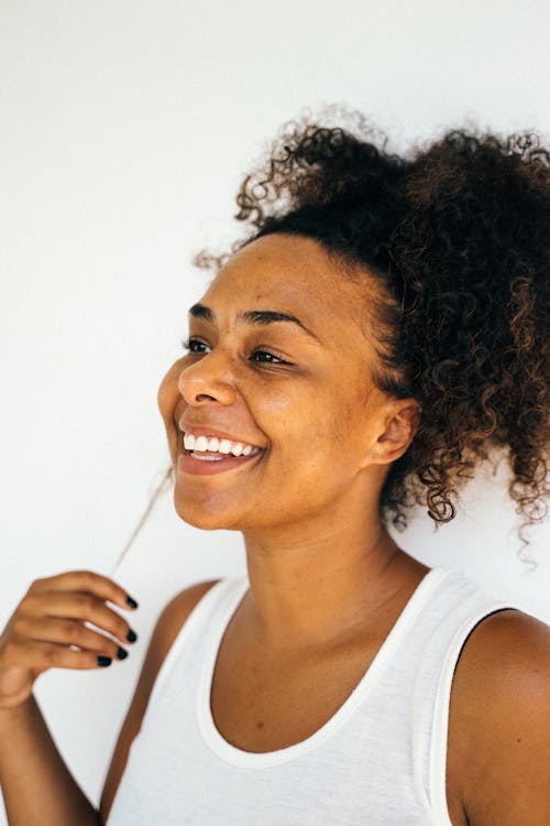 Portrait of a Woman in a White Tank Top Smiling