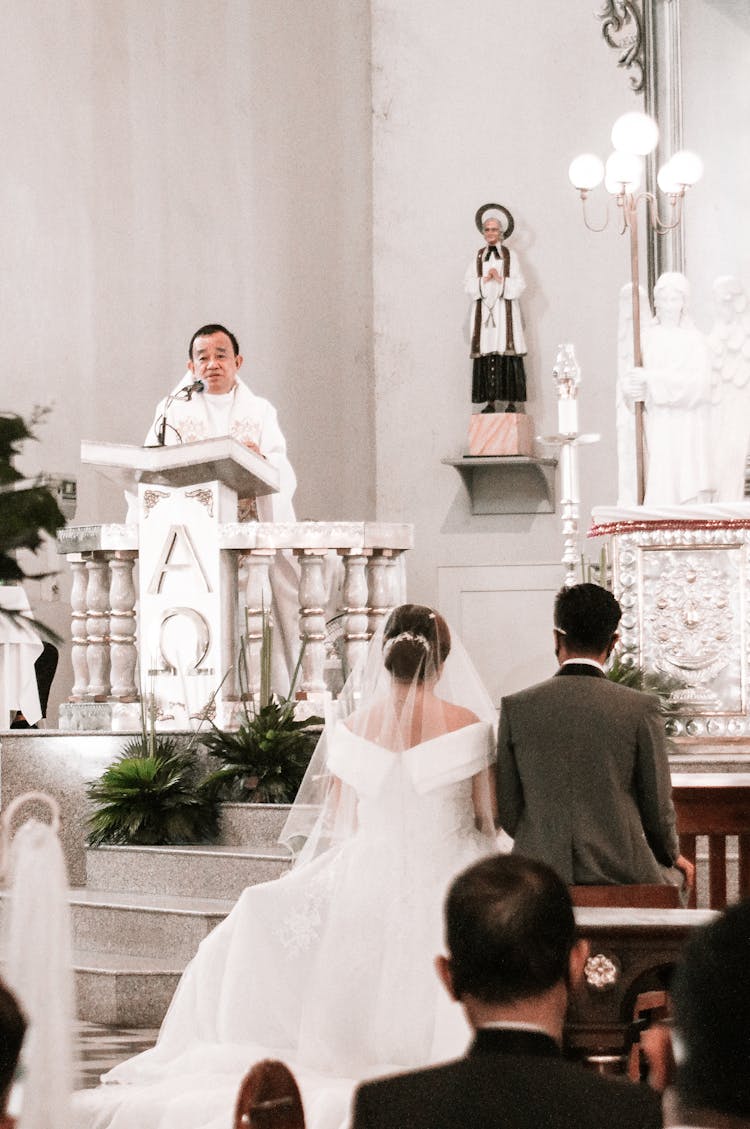 Priest At Wedding Ceremony In Church