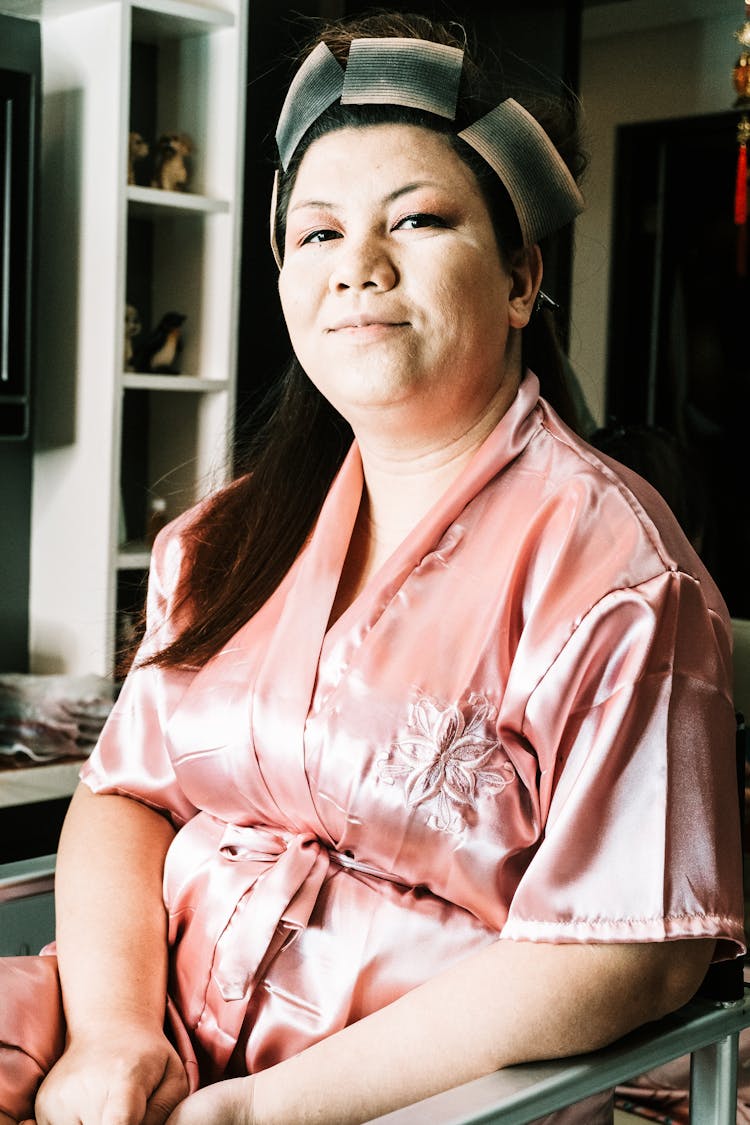 Positive Plump Woman In Silk Robe Preparing For Event