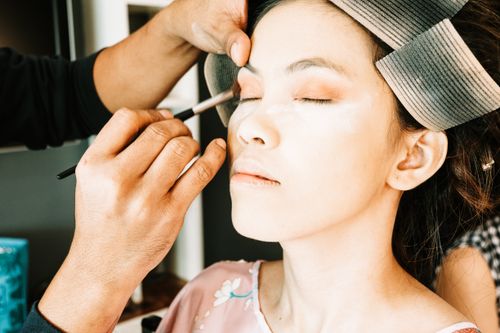 Free Close-up of a woman getting professional eye makeup applied by a makeup artist. Stock Photo