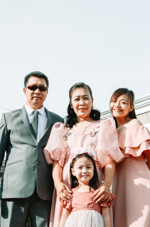 Free A family posing outdoors in formal attire, conveying warmth and togetherness. Stock Photo