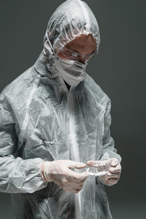 Man in Gray Leather Jacket Holding Clear Drinking Glass