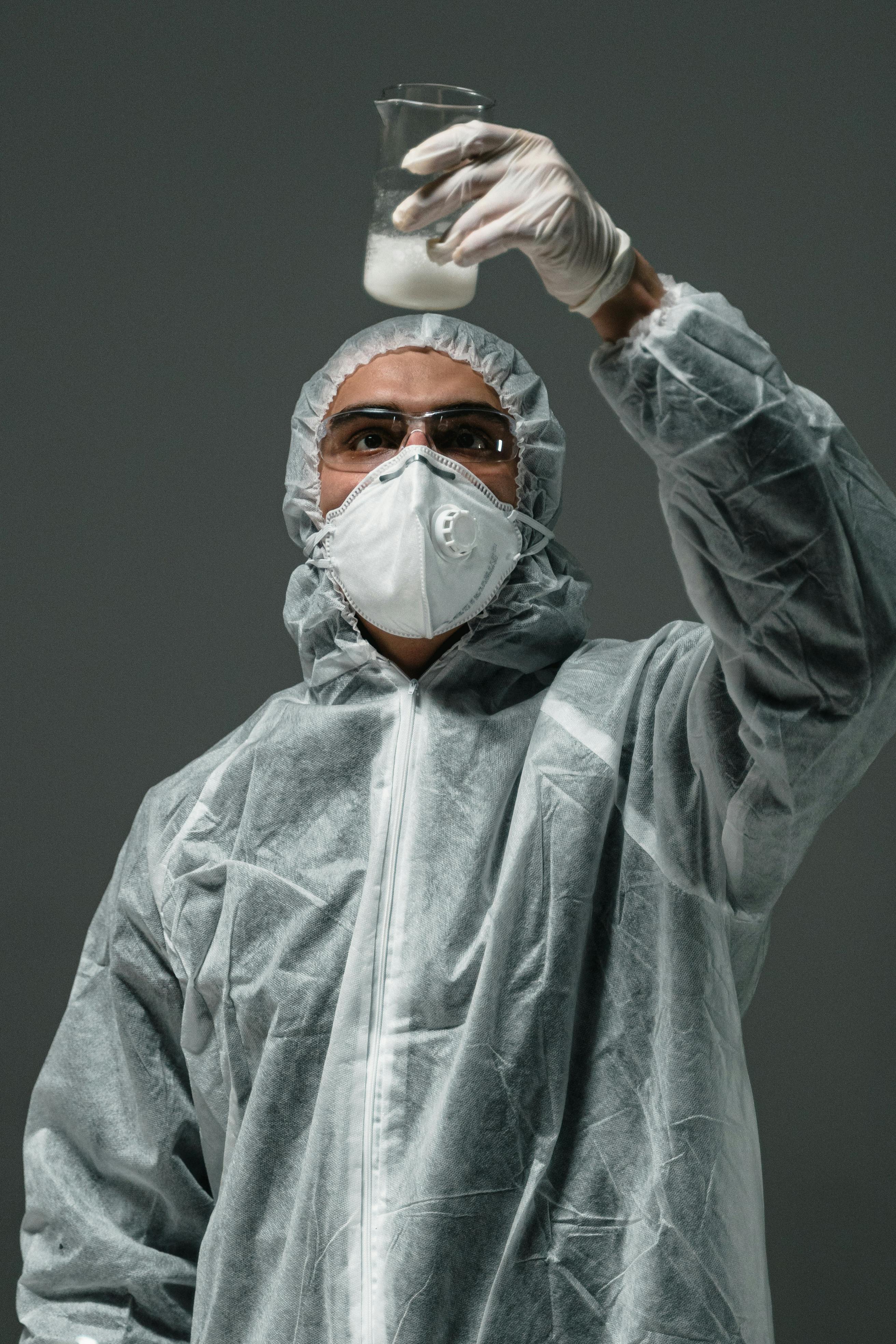 man in gray zip up jacket wearing white mask