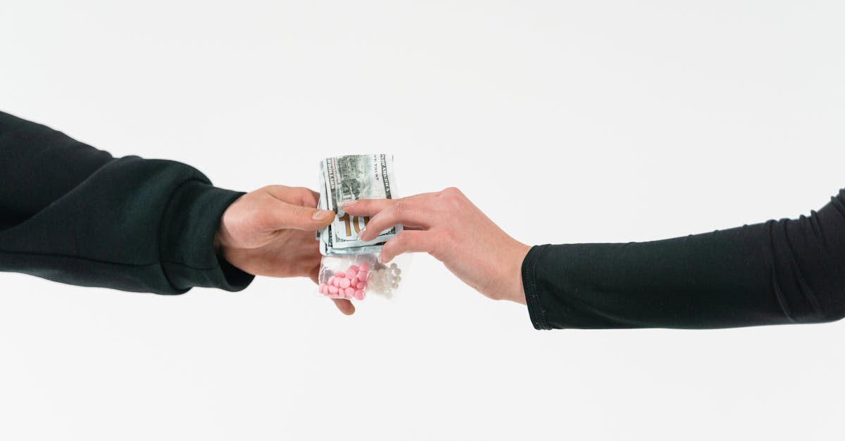 Person holding clear drinking glass