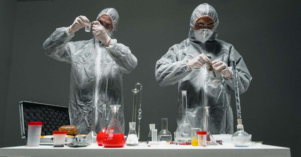 Two scientists in personal protective equipment performing experiments in a laboratory. - Evidence evidence guide for beetroot reaction time randomized trial