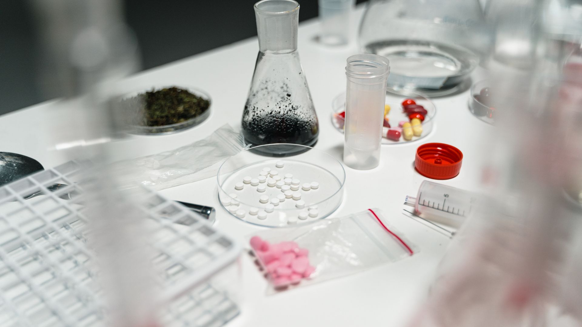 modafinil sample pack trial offer: Explore the Best Deals A laboratory table displaying pills, petri dishes, and chemical beakers for scientific research — modafinil sample pack trial offer