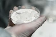 A Person Holding a Specimen Glass with Powder