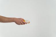 Person Holding Clear Glass Bottle