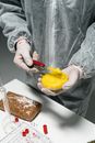 Hands with Round Container with Yellow Bubbles