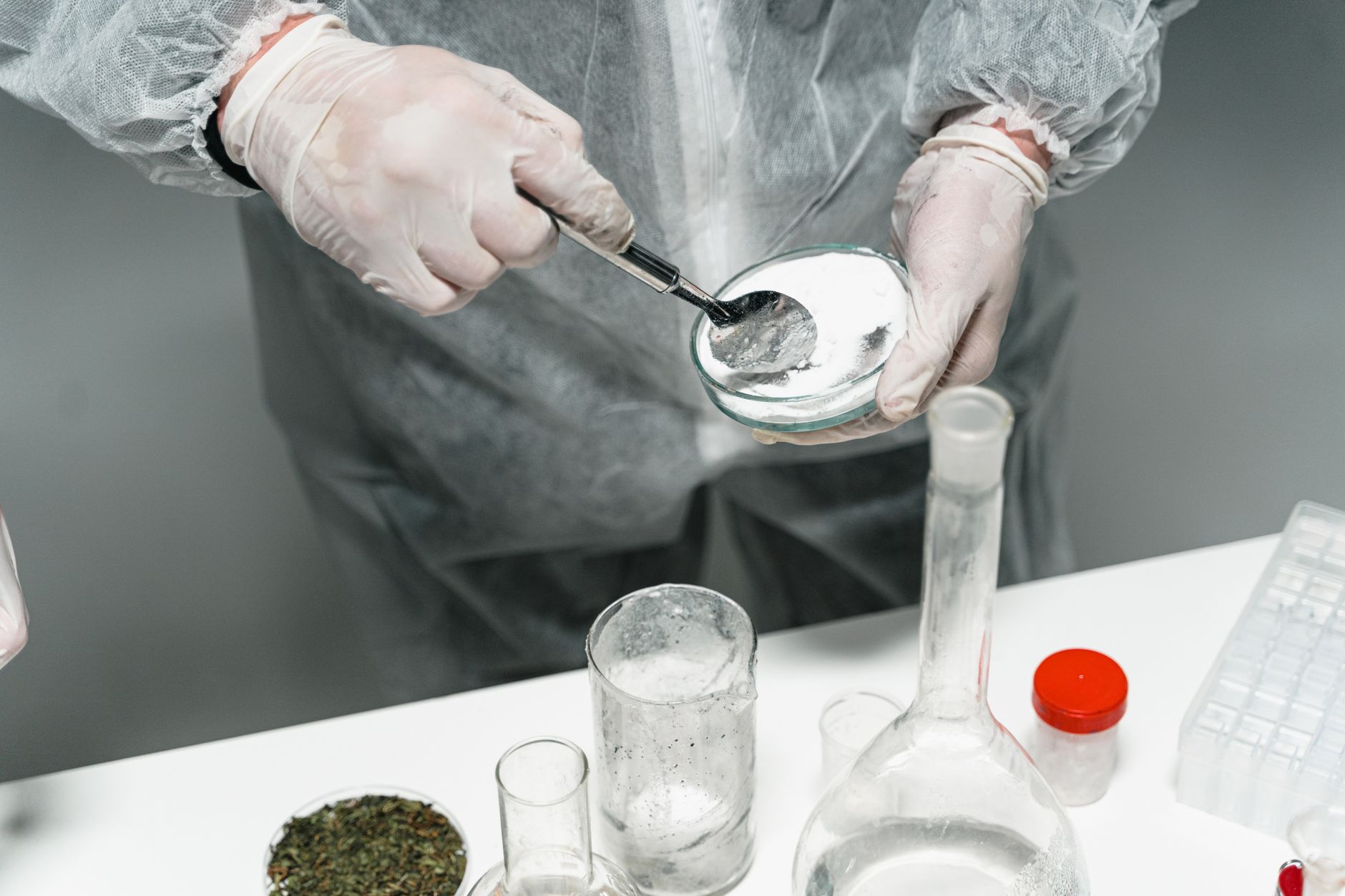 Laboratory powder sample being handled during supplement contamination testing